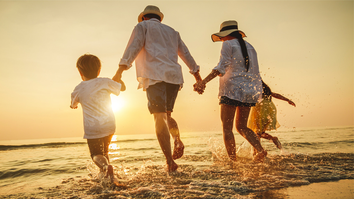 Family running into water